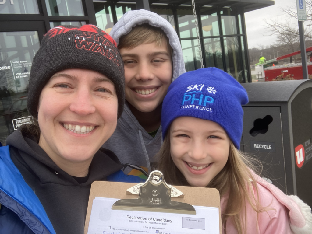 Beth and her two children with her Declaration of Candidacy paperwork